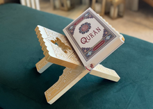 Load image into Gallery viewer, Quran on a wooden stand with a blurred indoor background