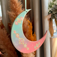 Load image into Gallery viewer, Decorative crescent moon with floral patterns hanging against a neutral background