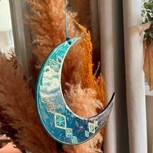 Load image into Gallery viewer, Decorative blue crescent moon with geometric patterns on a white vase with dried pampas grass.