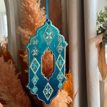 Load image into Gallery viewer, Decorative blue and turquoise hanging ornament with intricate patterns on a neutral background.