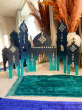 Load image into Gallery viewer, Decorative arches with intricate designs on a teal rug.