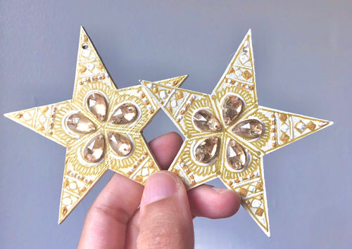 Ivory stars with gold gems and white and gold painted details.