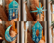 Load image into Gallery viewer, Set of four decorative resin ornaments in teal with star, crescent, and geometric shapes against a neutral background.