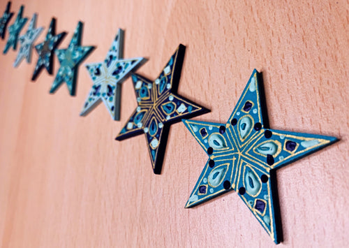 teal dark blue and mint green stars with hand painted details